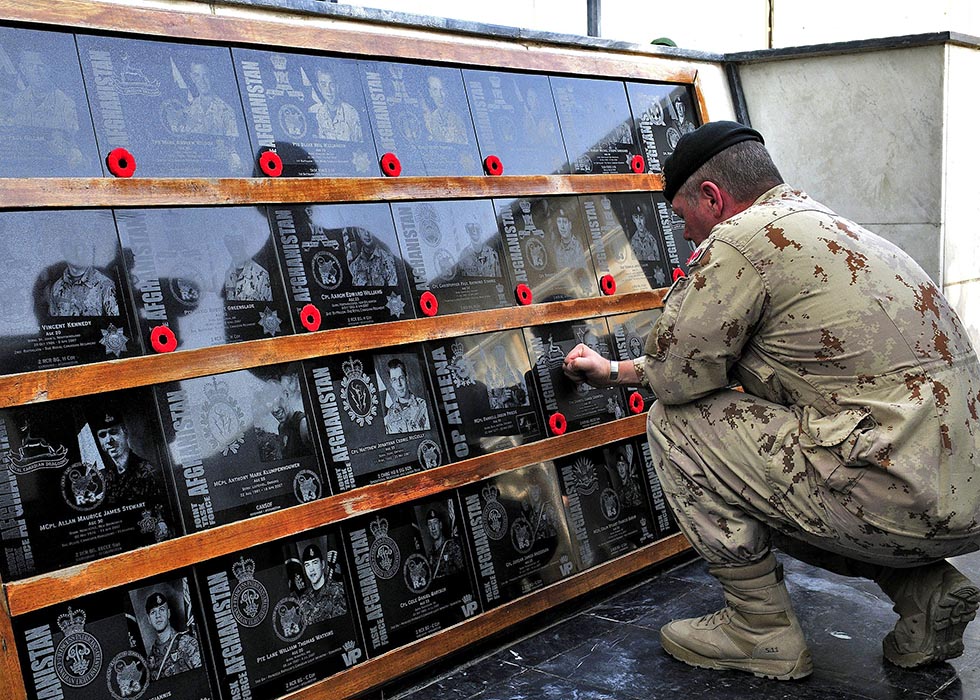 Director of Staff, Strategic Joint Staff, Major-General Jonathan Vance places poppies on every plaque on the Memorial of the Fallen at Kandahar Airfield during the last Remembrance Day ceremony in Southern Afghanistan on November 11, 2011.
Photo: Sergeant Lance Wade, Mission Transition Task Force Headquarters. ©2011 DND/MDN Canada.