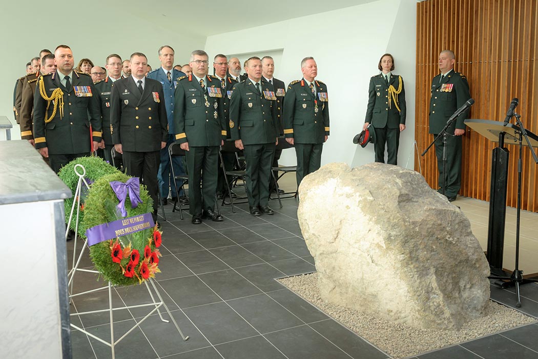 Honoured guests stand during the dedication of the Kandahar Cenotaph in the Afghanistan Memorial Hall at National Defence Headquarters (Carling) on May 13, 2019. Photo: Master Corporal Levarre McDonald, Canadian Forces Support Unit (Ottawa). ©2019 DND/MDN Canada.