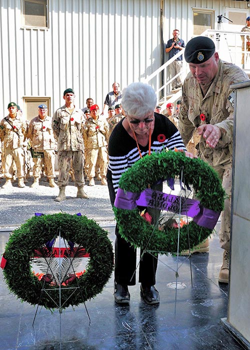 The Silver Cross mother, Mrs. Mabel Girouard, mother of fallen Chief Warrant Officer Robert Girouard, places a wreath on behalf of "Fallen Soldiers" at the Memorial of the Fallen at Kandahar Airfield during the last Remembrance Day ceremony of Joint Task Force Afghanistan on November 11, 2011.
Photo: Sergeant Lance Wade, Mission Transition Task Force Headquarters. ©2011 DND/MDN Canada.