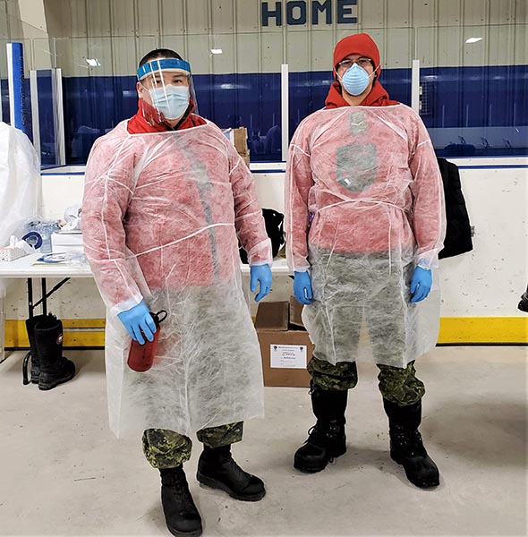 Sergeant Byron Corston and Ranger Nathaniel Keesic wear protective gowns